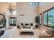 Bright living room featuring large windows, a chandelier, and modern furniture at 9445 Aspen Hill Cir, Lone Tree, CO 80124