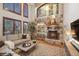 Inviting living room with stone fireplace, soaring ceilings, and large windows at 9445 Aspen Hill Cir, Lone Tree, CO 80124