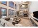 This spacious living room boasts a stone fireplace, large windows, and comfortable sectional sofa at 9445 Aspen Hill Cir, Lone Tree, CO 80124