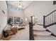 Open living room with high ceilings, clerestory windows, fireplace and adjacent staircase at 9445 Aspen Hill Cir, Lone Tree, CO 80124