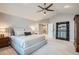Spacious main bedroom with neutral tones, a ceiling fan, plush carpeting, and a large window at 9445 Aspen Hill Cir, Lone Tree, CO 80124