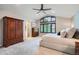 Comfortable main bedroom with hardwood furniture, vaulted ceiling, and oversized windows at 9445 Aspen Hill Cir, Lone Tree, CO 80124