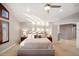 Bright main bedroom with vaulted ceiling, fan, and hardwood floors at 9445 Aspen Hill Cir, Lone Tree, CO 80124