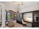 Stylish office with built-in shelving and a dark wood desk and an inviting window seat at 9445 Aspen Hill Cir, Lone Tree, CO 80124