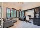 Cozy home office with built-in shelves, a comfortable chair, and ample natural light at 9445 Aspen Hill Cir, Lone Tree, CO 80124