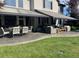 Backyard patio features outdoor dining and seating beneath a retractable awning, with manicured lawn at 9445 Aspen Hill Cir, Lone Tree, CO 80124