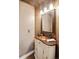 Charming powder room with decorative vanity, mirror, and warm lighting at 9445 Aspen Hill Cir, Lone Tree, CO 80124