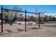 Playground swings with slides nearby and mature trees providing shade on a sunny day at 9445 Aspen Hill Cir, Lone Tree, CO 80124