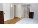Bright bedroom featuring wood floors, a dresser, and closet doors at 95 S Eagle Cir, Aurora, CO 80012