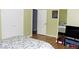 A vibrant green bedroom featuring wood floors and patterned bedding at 95 S Eagle Cir, Aurora, CO 80012