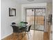 Cozy dining area with a glass table, leading to a backyard view through sliding glass doors at 95 S Eagle Cir, Aurora, CO 80012