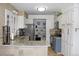 Well-lit kitchen featuring white cabinetry, granite countertops, stainless steel appliances, and modern fixtures at 95 S Eagle Cir, Aurora, CO 80012