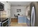 A modern kitchen features stainless steel appliances and blue lower cabinets at 95 S Eagle Cir, Aurora, CO 80012