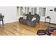 Bright living room with hardwood floors, comfortable sofa, and large windows offering natural light at 95 S Eagle Cir, Aurora, CO 80012