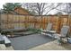 Outdoor patio area with chairs, a small table, a dark rug and a flower bed at 95 S Eagle Cir, Aurora, CO 80012