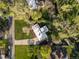 Aerial view of home featuring lush landscaping, a long driveway, and mature trees at 11900 W 18Th Ave, Lakewood, CO 80215