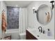 A stylish bathroom showcases modern fixtures, a sleek vanity, and unique tile work, blending form with functionality at 11900 W 18Th Ave, Lakewood, CO 80215