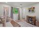 A cozy Bedroom features a crib, changing table, and charming decor that creates a warm and inviting space at 11900 W 18Th Ave, Lakewood, CO 80215