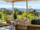 Relax on this covered patio with wicker seating that offers breathtaking views of the surrounding landscape at 11900 W 18Th Ave, Lakewood, CO 80215