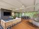A spacious covered patio includes both a cozy lounge area and a dining space, perfect for year-round outdoor living at 11900 W 18Th Ave, Lakewood, CO 80215