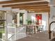 Bright dining area with exposed beams, modern lighting, and a view of the surrounding trees at 11900 W 18Th Ave, Lakewood, CO 80215