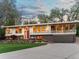 Stunning modern home with a large front yard, rock garden, covered balcony, and an attached garage at 11900 W 18Th Ave, Lakewood, CO 80215