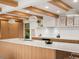 Modern kitchen featuring a large island, custom cabinetry, white countertops and exposed wood beams at 11900 W 18Th Ave, Lakewood, CO 80215