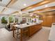 Open-concept kitchen with a large island, modern appliances, and exposed wood beams at 11900 W 18Th Ave, Lakewood, CO 80215