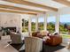 Cozy living room with a brick fireplace, comfortable seating, and large windows with scenic views at 11900 W 18Th Ave, Lakewood, CO 80215