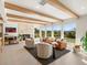 Spacious living room with exposed wood beams, a cozy fireplace, and expansive views of the landscape at 11900 W 18Th Ave, Lakewood, CO 80215