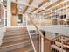 Open-concept living space with beam ceiling and modern staircase at 11900 W 18Th Ave, Lakewood, CO 80215
