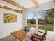 Bright home office featuring beam ceiling, modern desk, and view of exterior landscape at 11900 W 18Th Ave, Lakewood, CO 80215