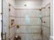 Close up of the shower with glass doors and gold hardware at 11900 W 18Th Ave, Lakewood, CO 80215