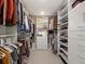 Spacious walk-in closet featuring ample shelving and storage space for clothes and shoes at 11900 W 18Th Ave, Lakewood, CO 80215