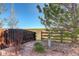 Fenced backyard with a gate leading to an open field, showcasing privacy and access at 1909 Alpine Dr, Erie, CO 80516