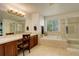 Large bathroom with double vanity, tub, and glass shower; bright and spacious at 1909 Alpine Dr, Erie, CO 80516