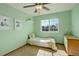 Bright bedroom featuring a large window, mint walls and comfortable neutral bedding at 1909 Alpine Dr, Erie, CO 80516