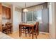 Cozy dining area featuring a dark accent wall, window coverings, and a table with seating for four at 1909 Alpine Dr, Erie, CO 80516