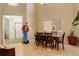 This inviting dining area is accentuated by an abundance of natural light, table for six, and soaring ceilings at 1909 Alpine Dr, Erie, CO 80516