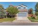 Charming two-story home with a well-maintained front yard and a gray two-car garage at 1909 Alpine Dr, Erie, CO 80516
