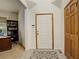 Inviting foyer with tile flooring and a view into an office with a built-in bookcase at 1909 Alpine Dr, Erie, CO 80516