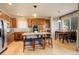 Spacious kitchen with stainless steel appliances, granite counters, island with seating and adjacent dining area at 1909 Alpine Dr, Erie, CO 80516