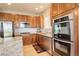 Well-appointed kitchen featuring stainless appliances, including double oven, granite counters and ample cabinet space at 1909 Alpine Dr, Erie, CO 80516
