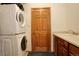 A functional laundry room with a washer, dryer, and sink area at 1909 Alpine Dr, Erie, CO 80516