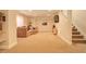 Spacious basement living area featuring a comfortable sofa, TV, and staircase to upper level at 1909 Alpine Dr, Erie, CO 80516