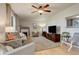 Cozy living room featuring neutral tones, wood floors, a ceiling fan, and a fireplace at 1909 Alpine Dr, Erie, CO 80516
