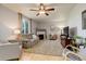 Cozy living room featuring neutral tones, wood floors, a ceiling fan, and a fireplace at 1909 Alpine Dr, Erie, CO 80516
