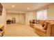 Basement living room area featuring a cozy sofa, study desk and bright recessed lighting at 1909 Alpine Dr, Erie, CO 80516