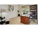 Bright home office featuring a large desk, built-in bookshelves, and a comfortable chair at 1909 Alpine Dr, Erie, CO 80516