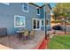 Cozy patio area with outdoor furniture, string lights, and access to the home's interior at 1909 Alpine Dr, Erie, CO 80516